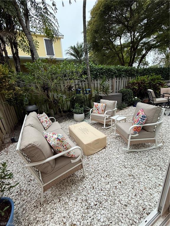 302 2nd Street South, Unit 302 Naples, FL 34102 - Photo 13 of 14 a view of backyard with couple of couch and trees