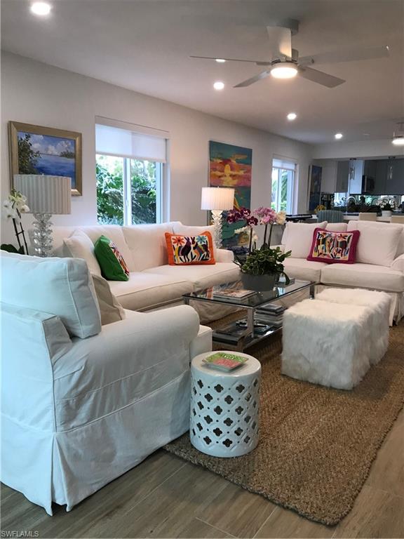 302 2nd Street South, Unit 302 Naples, FL 34102 - Photo 3 of 14 a living room with furniture a large window and a chandelier