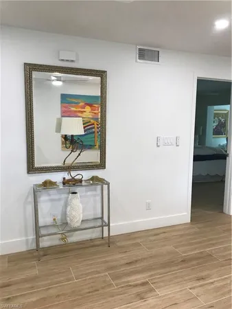 a room with wooden floor and furniture