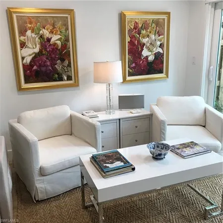 a living room with furniture a couch and wall paintings