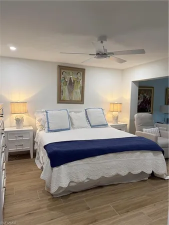 a living room with furniture a table and a painting on the wall