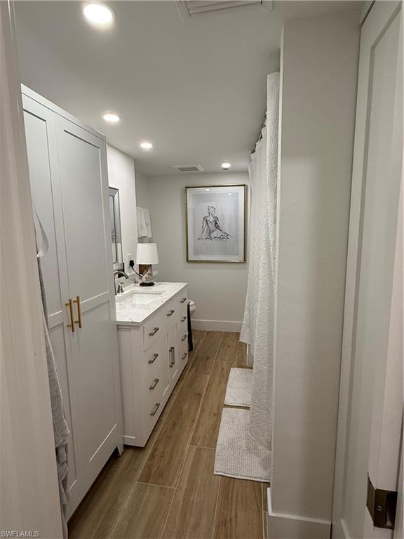 302 2nd Street South, Unit 302 Naples, FL 34102 - Photo 10 of 14 a bathroom with a sink a mirror and a toilet