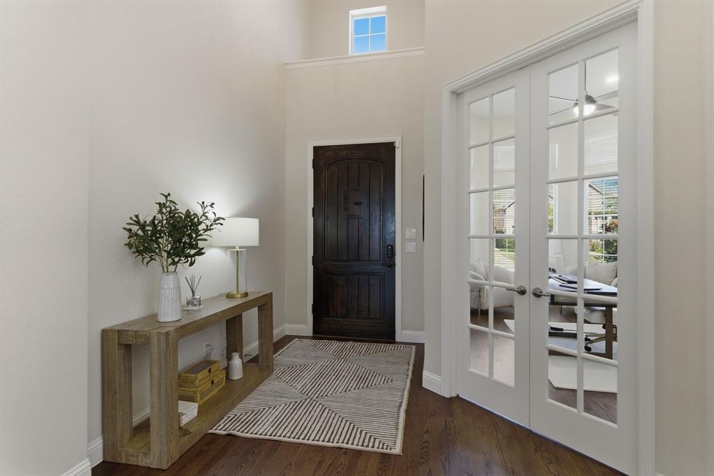 2801 Seabiscuit Road Celina, TX 75009 - Photo 2 of 39 Foyer entrance featuring french doors, plenty of natural light, dark wood-style floors, and a high ceiling