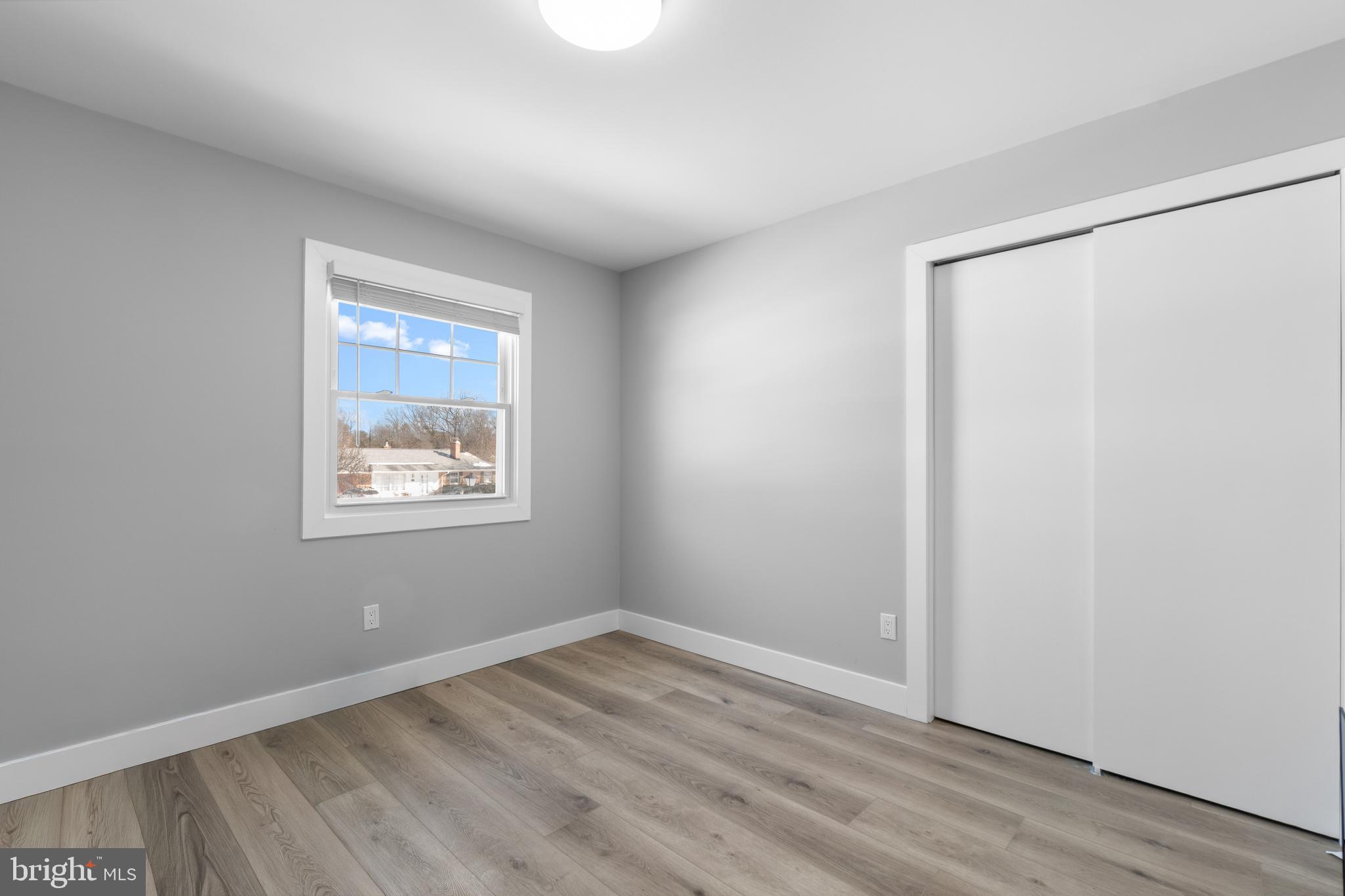 19104 Bloomfield Road Olney, MD 20832 - Photo 14 of 37 a view of an empty room with wooden floor and a window