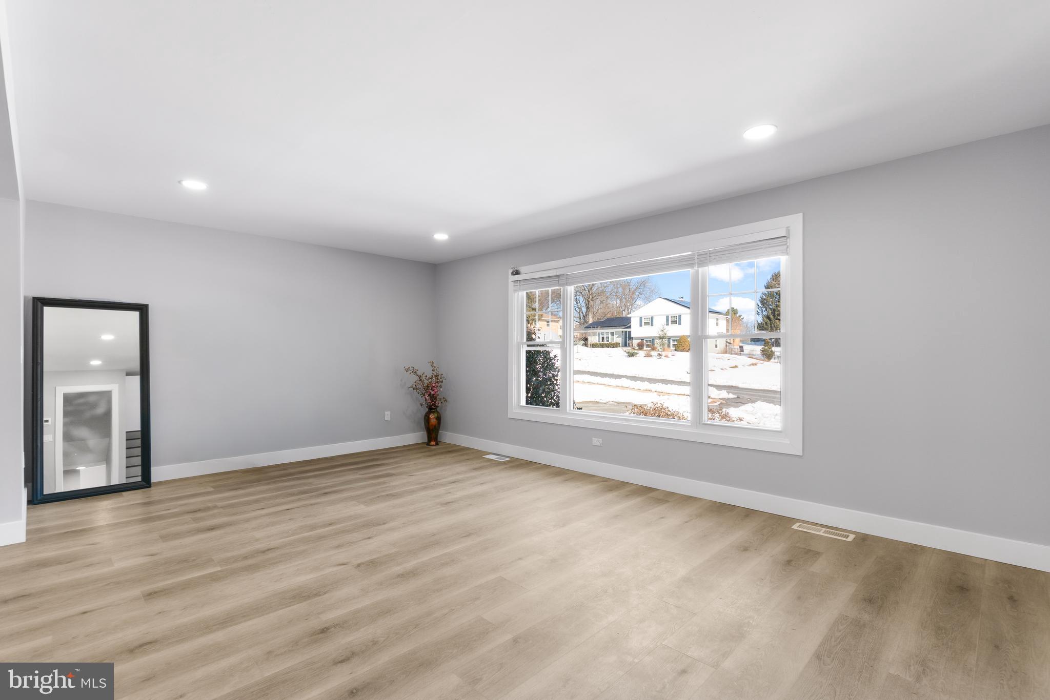 19104 Bloomfield Road Olney, MD 20832 - Photo 2 of 37 an empty room with wooden floor and windows