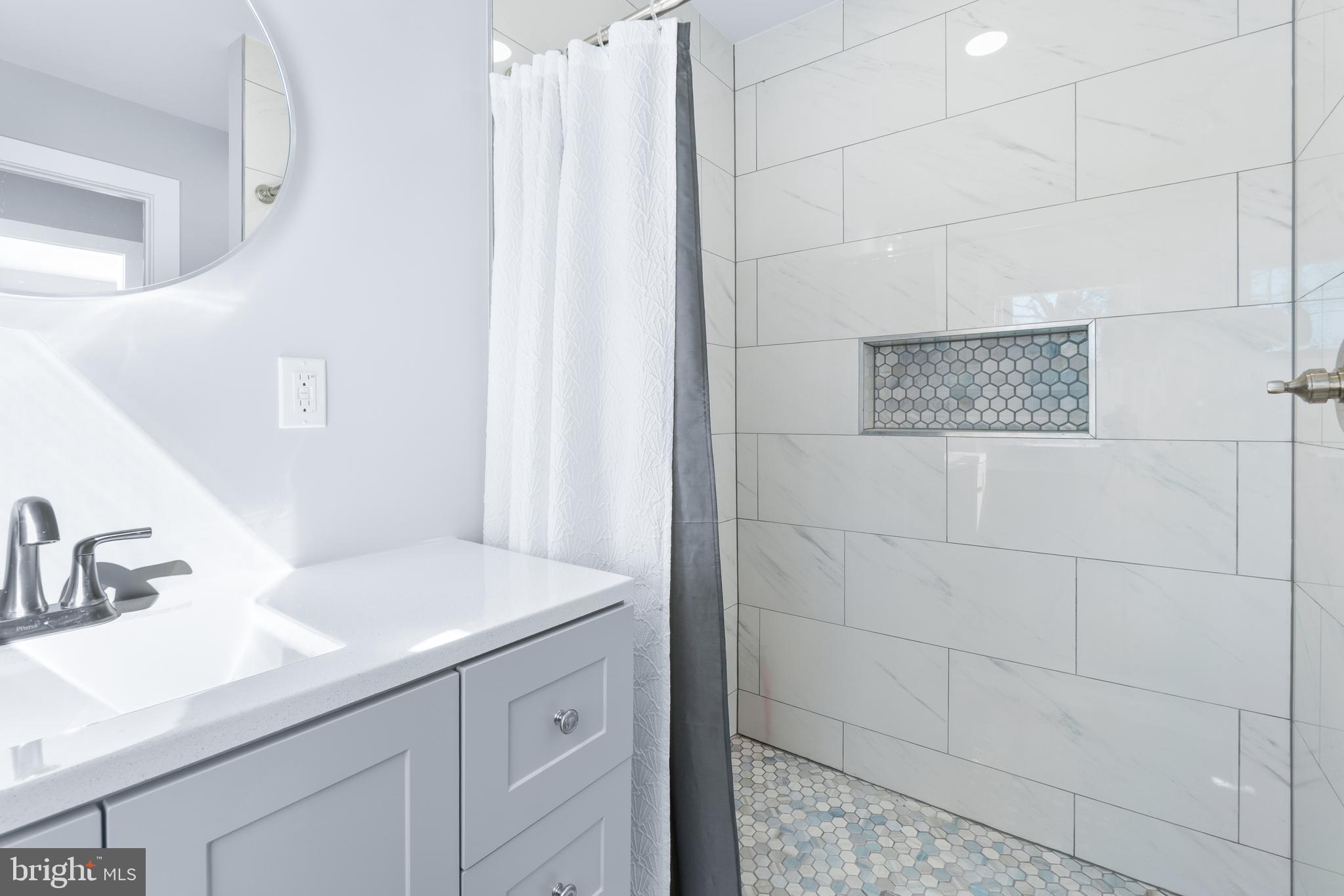 19104 Bloomfield Road Olney, MD 20832 - Photo 21 of 37 a bathroom with a sink and a mirror