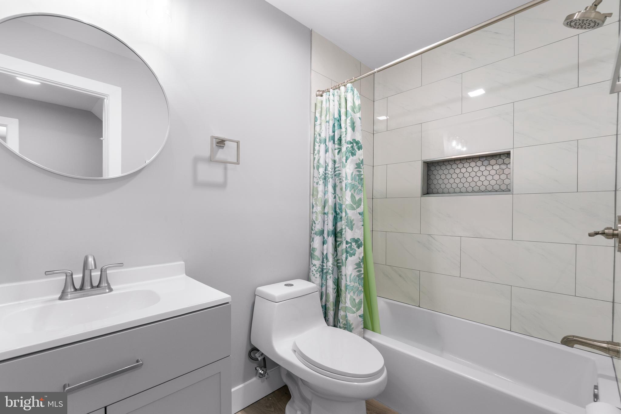 19104 Bloomfield Road Olney, MD 20832 - Photo 22 of 37 a bathroom with a sink a toilet and shower