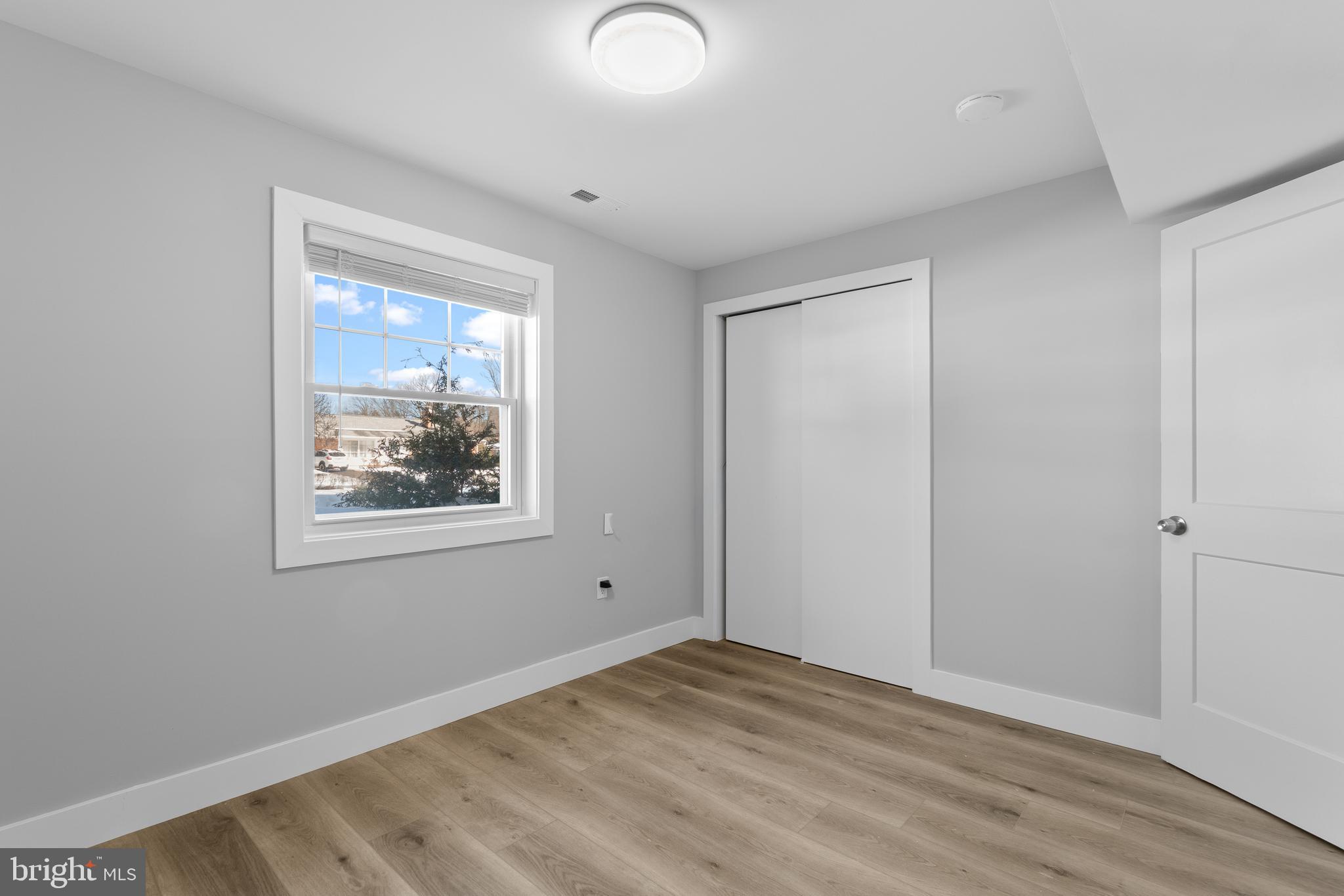 19104 Bloomfield Road Olney, MD 20832 - Photo 27 of 37 a view of an empty room with wooden floor and a window