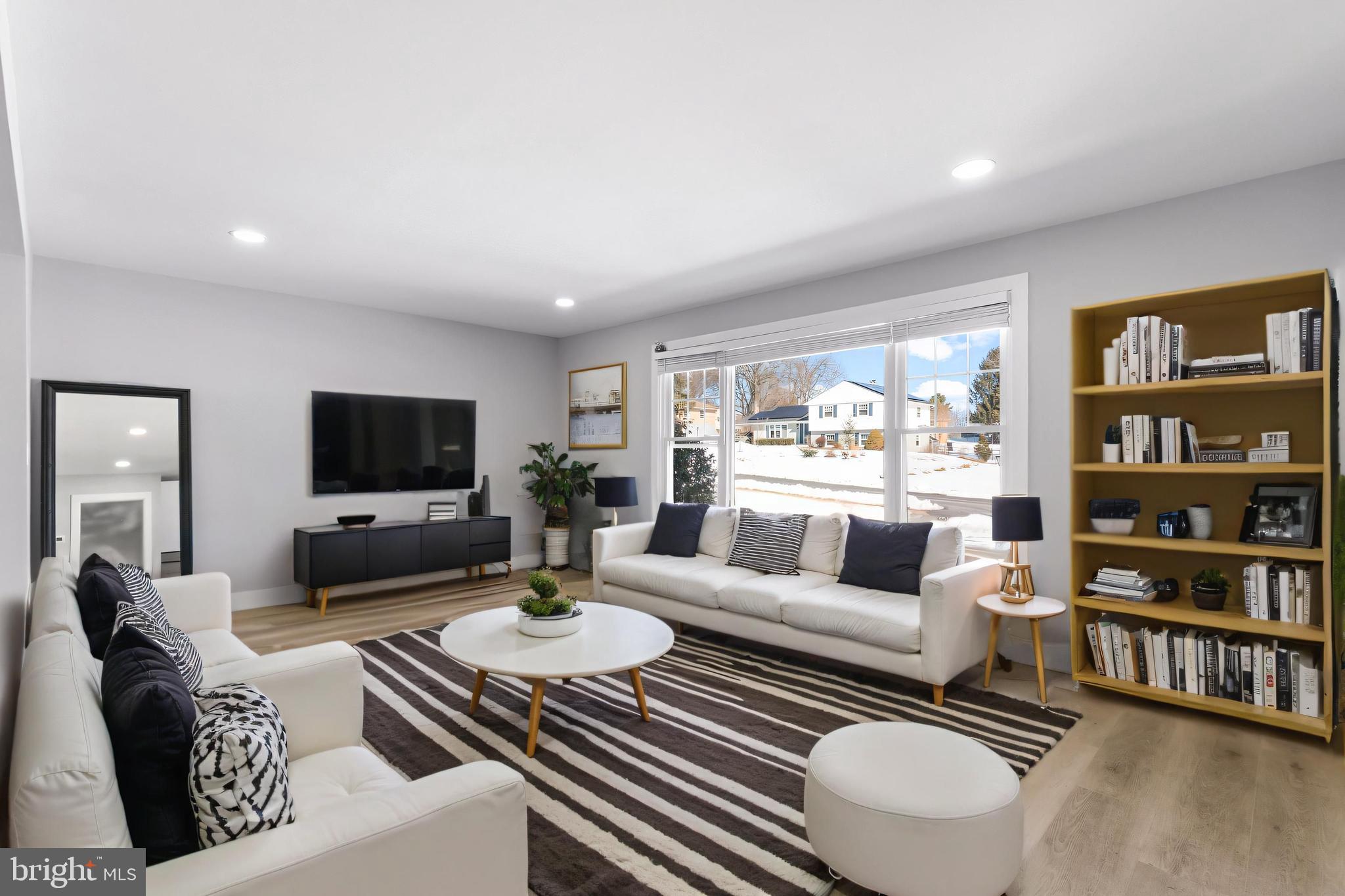 19104 Bloomfield Road Olney, MD 20832 - Photo 4 of 37 a living room with furniture a rug and a flat screen tv