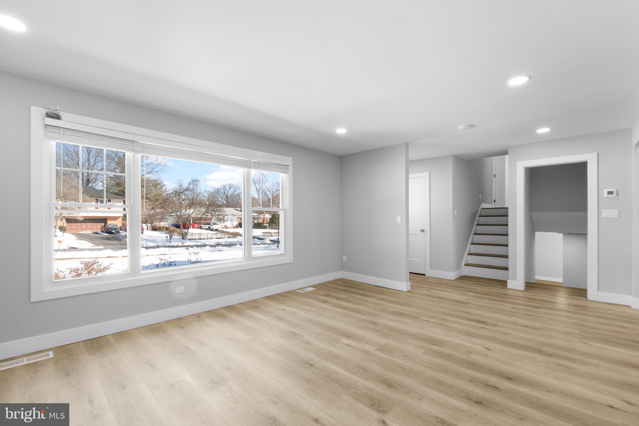 19104 Bloomfield Road Olney, MD 20832 - Photo 5 of 37 a view of an empty room with a window and wooden floor