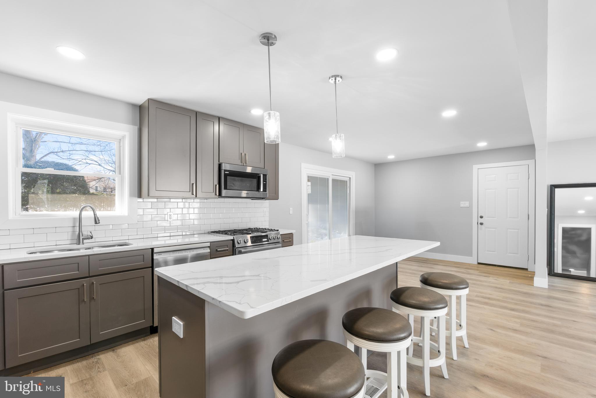 19104 Bloomfield Road Olney, MD 20832 - Photo 9 of 37 a kitchen with furniture a sink a counter space and stainless steel appliances