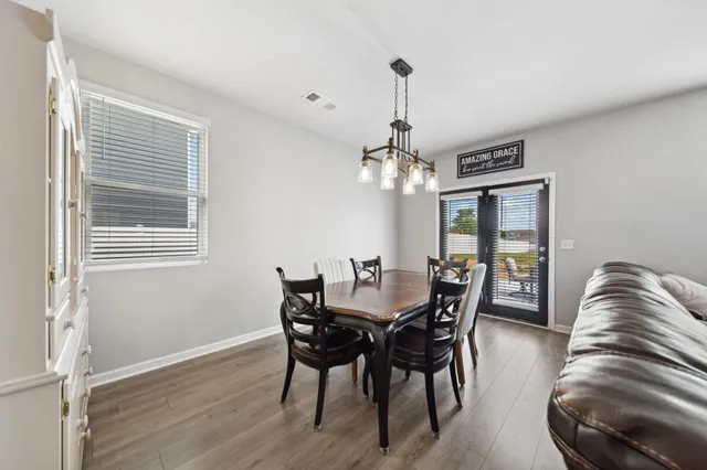 a bedroom with a bed dresser and a window