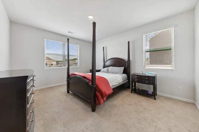 a spacious bedroom with a bed and a window