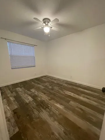 a view of a room with a ceiling fan