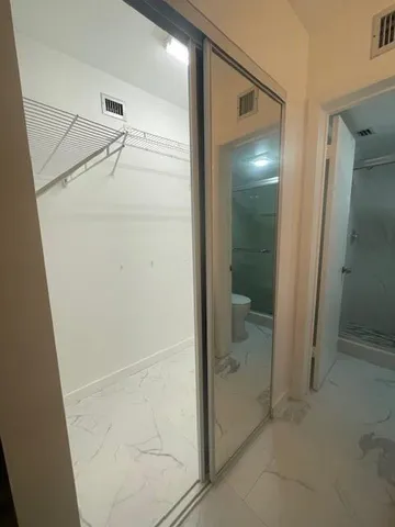 a kitchen with stainless steel appliances granite countertop a refrigerator and a stove