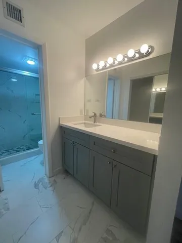 a view of an empty room with wooden floor and a floor to ceiling window