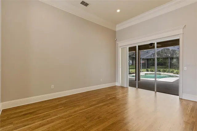 a view of a room with wooden floor and chandelier