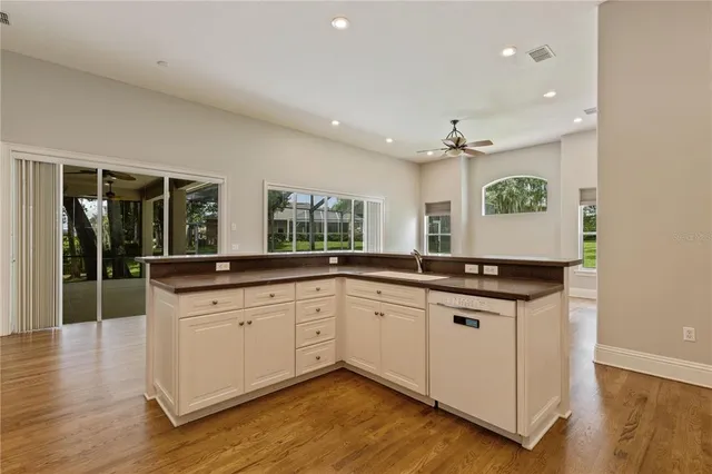 a kitchen with stainless steel appliances granite countertop a sink and a stove top oven