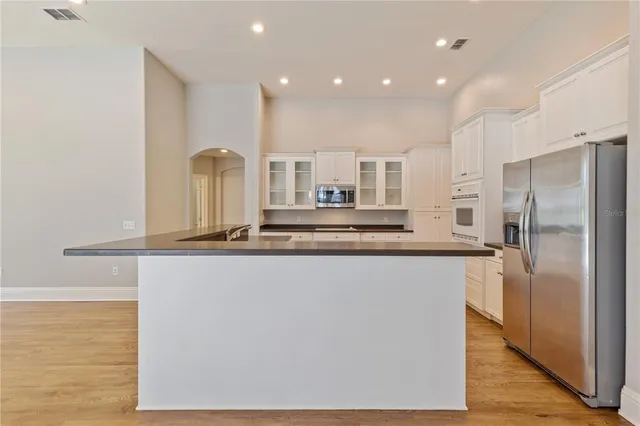 a view of a kitchen with a sink and a refrigerator