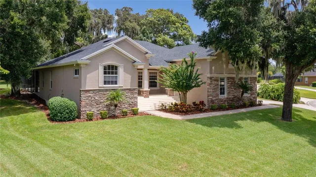 a front view of house with yard and green space
