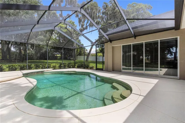 a view of a white building with swimming pool in front of it
