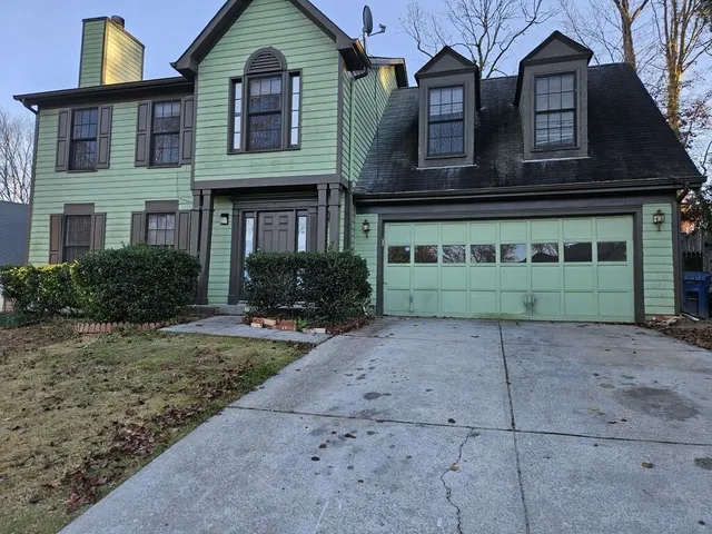 a front view of a house with garden