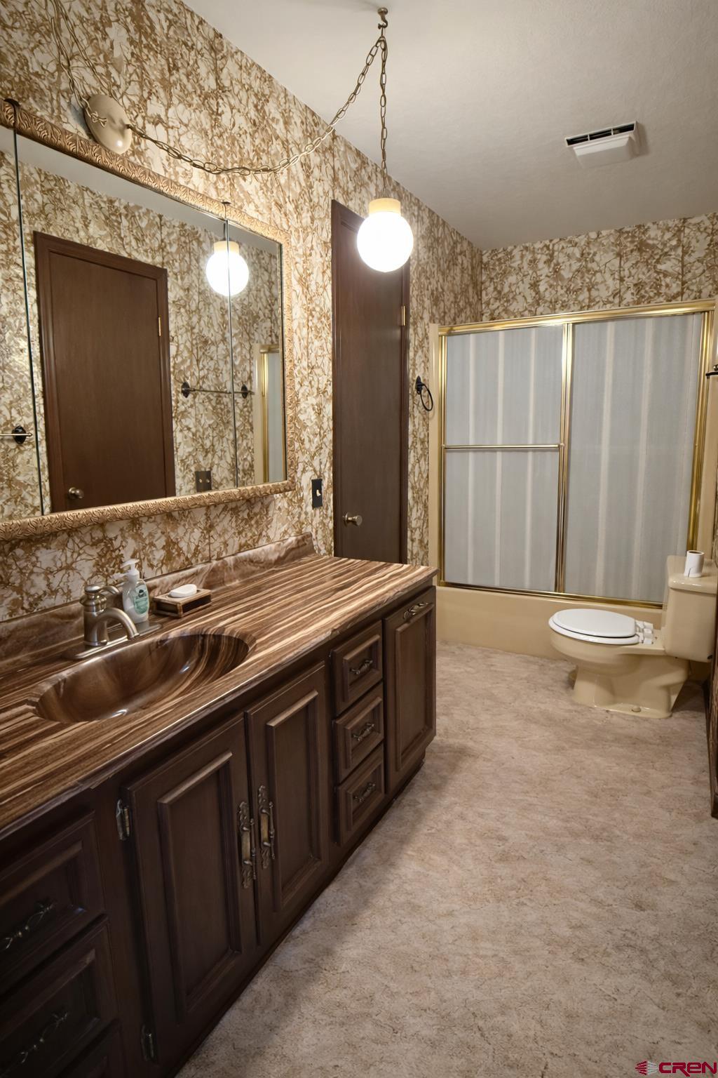 2323 Pioneer Road Delta, CO 81416 - Photo 21 of 35 a bathroom with a double vanity sink mirror and toilet