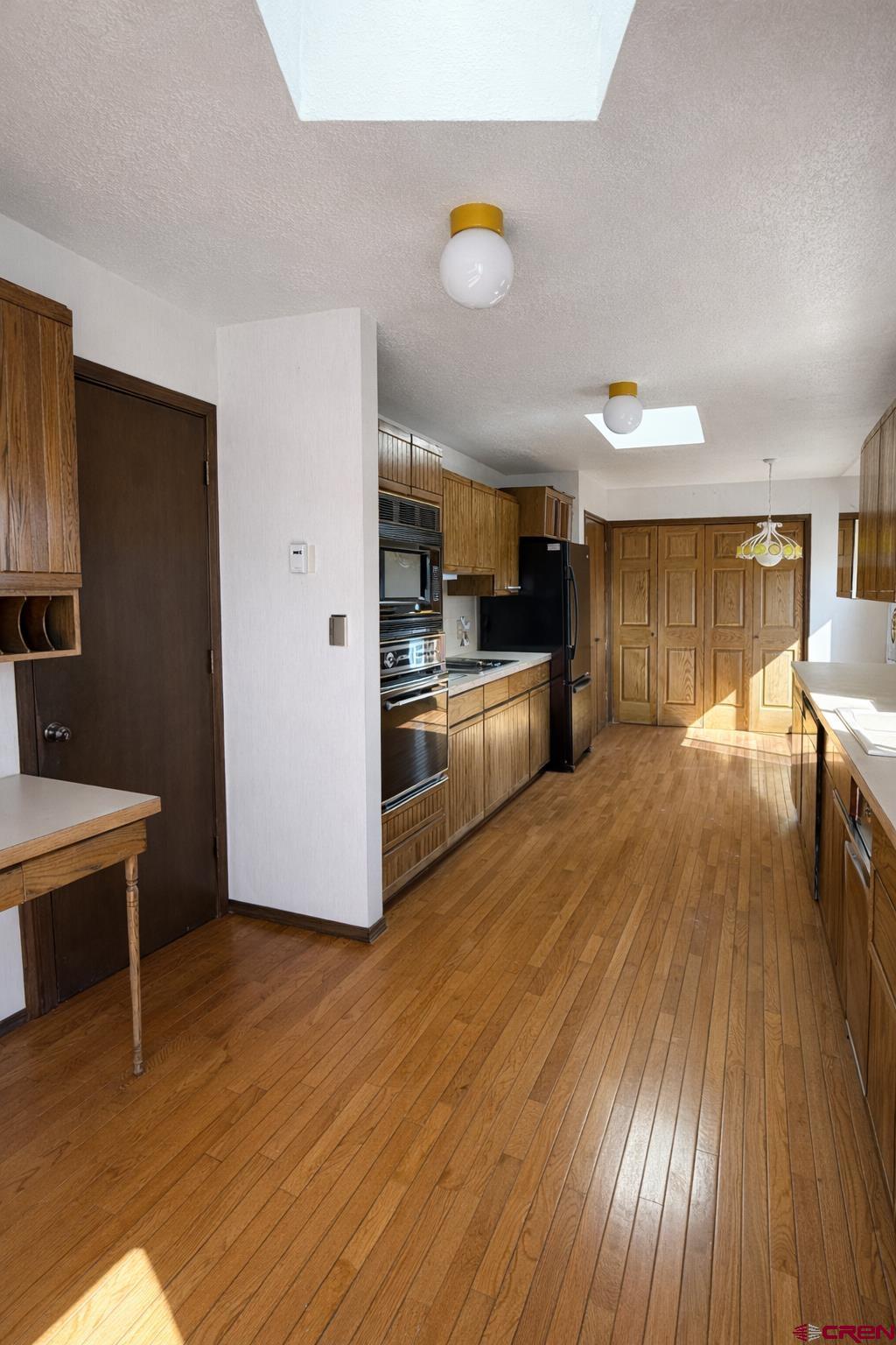 2323 Pioneer Road Delta, CO 81416 - Photo 7 of 35 a view of a kitchen with wooden floor and electronic appliances