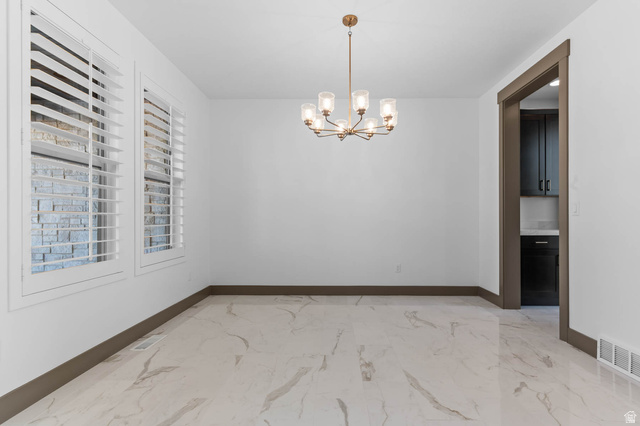 2724 Mt Jordan Road Sandy, UT 84092 - Photo 10 of 33 Unfurnished room with hanging lights and light marble finish flooring
