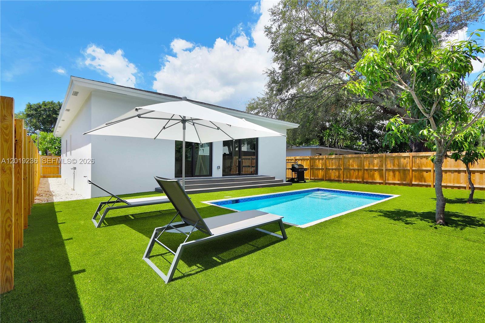 2001 Southwest 22nd Terrace Miami, FL 33145 - Photo 2 of 31 a view of a house with a backyard patio and swimming pool