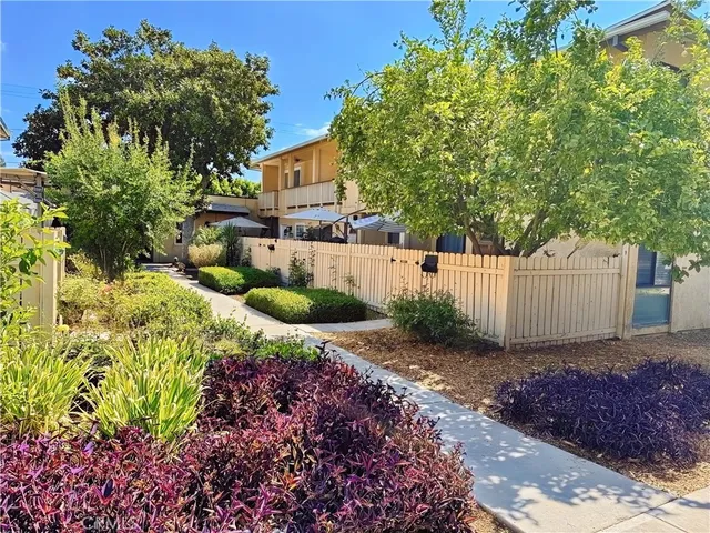 a front view of a house with a yard and shrubs