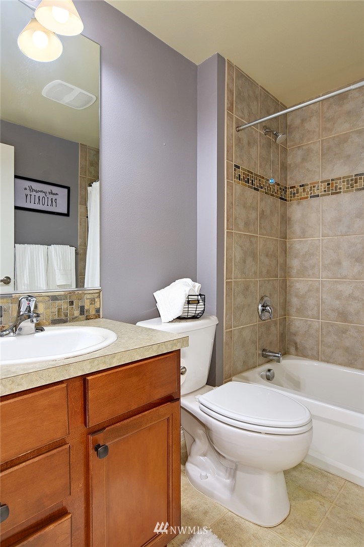 3112 Southwest Avalon Way, Unit 102 Seattle, WA 98126 - Photo 13 of 26 a bathroom with a sink a toilet and shower