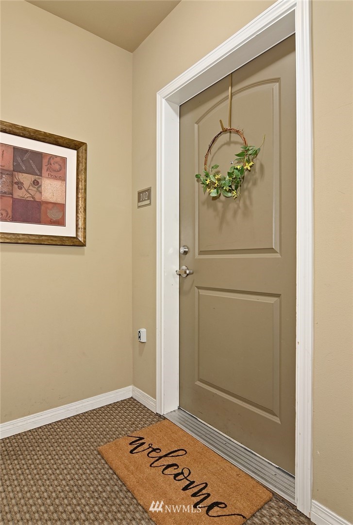 3112 Southwest Avalon Way, Unit 102 Seattle, WA 98126 - Photo 20 of 26 a view of a hallway with wooden floor and a dining table