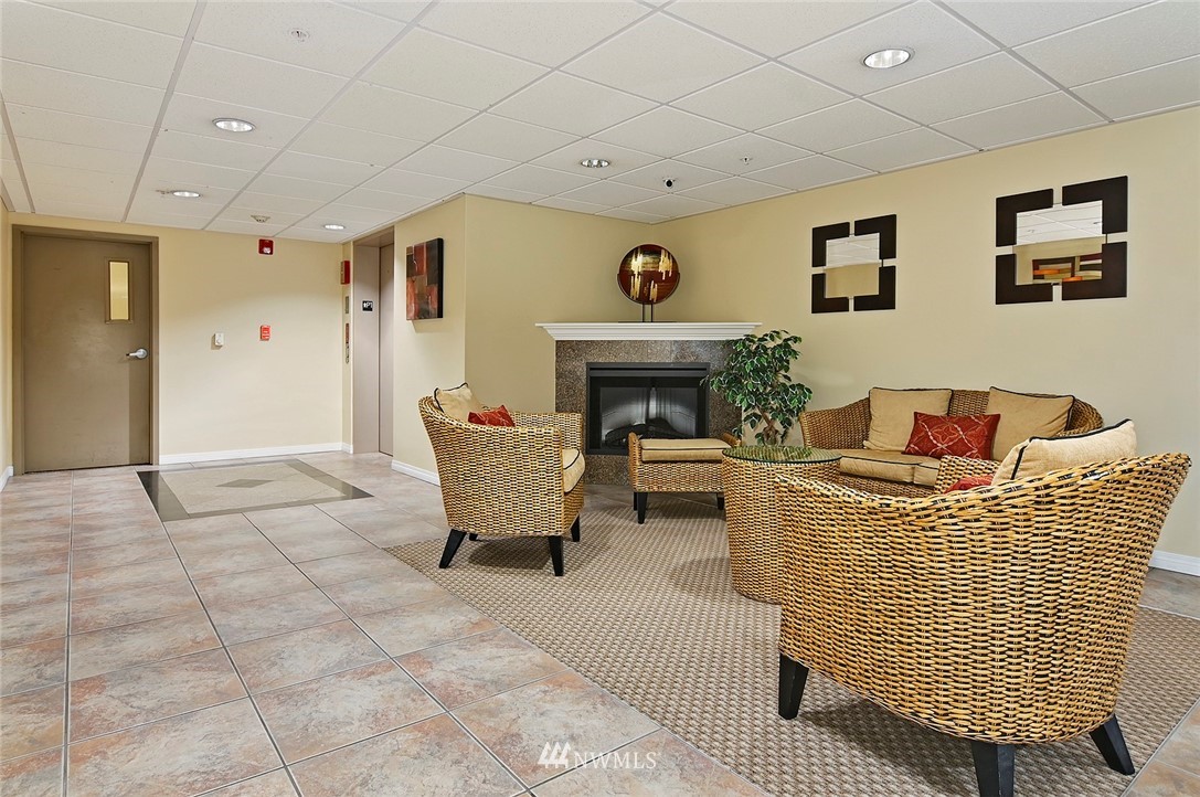 3112 Southwest Avalon Way, Unit 102 Seattle, WA 98126 - Photo 21 of 26 a living room with furniture and a fireplace