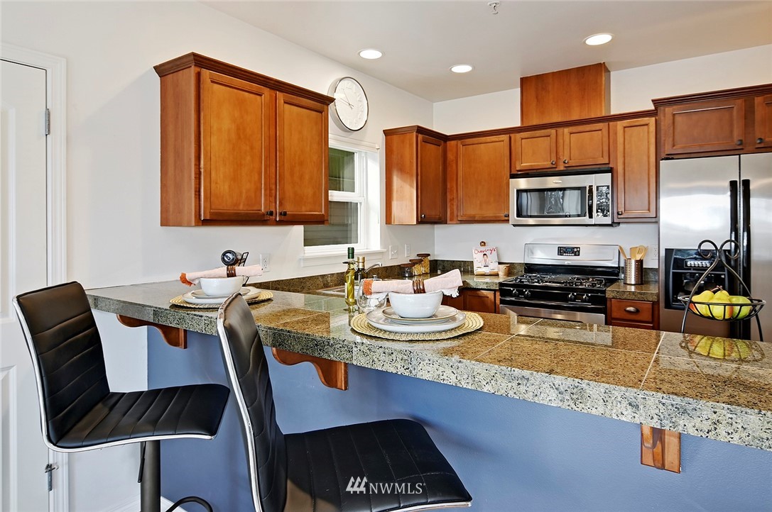 3112 Southwest Avalon Way, Unit 102 Seattle, WA 98126 - Photo 5 of 26 a kitchen with a sink and stove