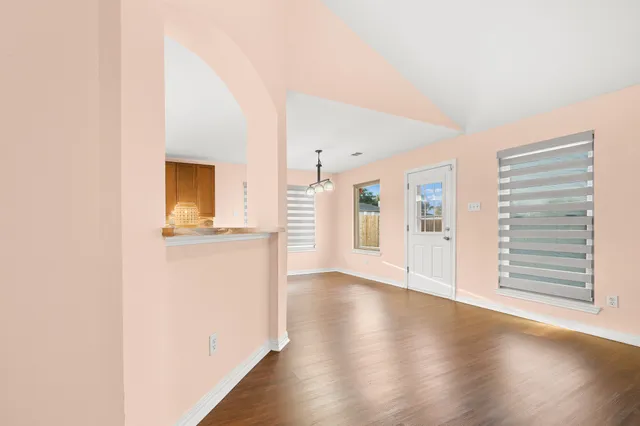 a view of a kitchen with wooden floor and a kitchen space