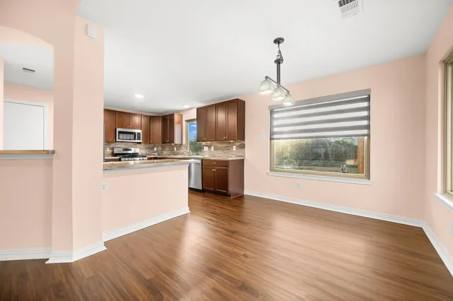 a kitchen with a refrigerator and a stove top oven