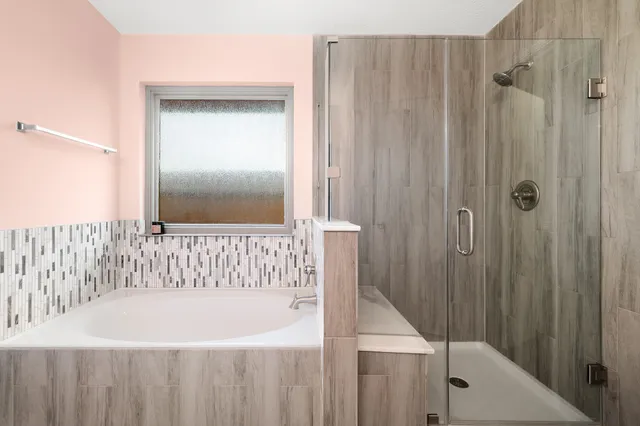 a bathroom with a bathtub and a shower