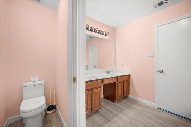 a view of bathroom with a toilet sink and mirror