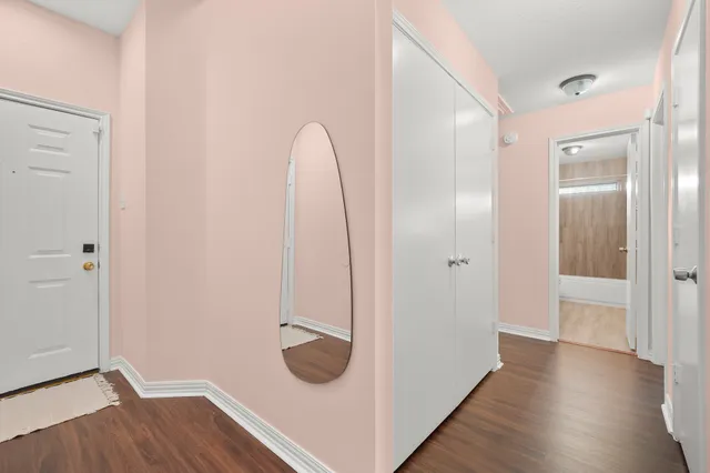 a view of a room with wooden floor