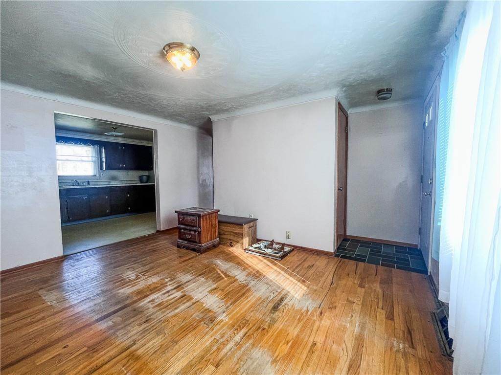 116 Pershing Drive Connellsville, PA 15425 - Photo 2 of 24 a bedroom with a bed and wooden floor