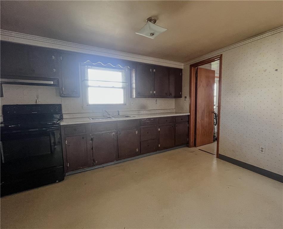 116 Pershing Drive Connellsville, PA 15425 - Photo 4 of 24 a kitchen with granite countertop a sink and cabinets