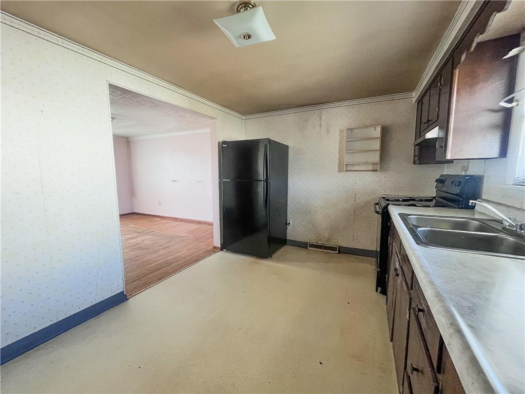 116 Pershing Drive Connellsville, PA 15425 - Photo 5 of 24 a kitchen with a sink and a refrigerator