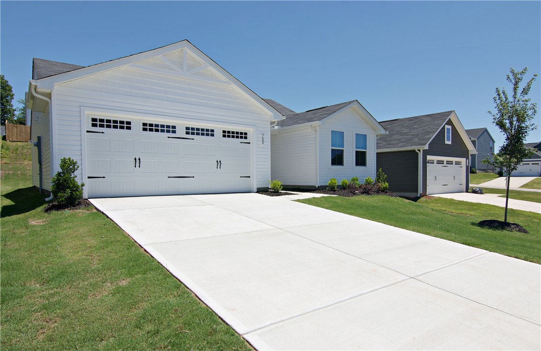 723 Peridot Way Westminster, SC 29693 - Photo 2 of 45 A fresh concrete driveway leads to a pristine new construction home with a prominent attached garage.