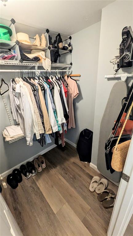101 South Gulfstream Avenue, Unit 7E Sarasota, FL 34236 - Photo 19 of 40 a view of walk in closet with clothes and shoes