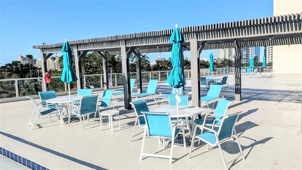 101 South Gulfstream Avenue, Unit 7E Sarasota, FL 34236 - Photo 28 of 40 a view of outdoor dining space with a table and chairs