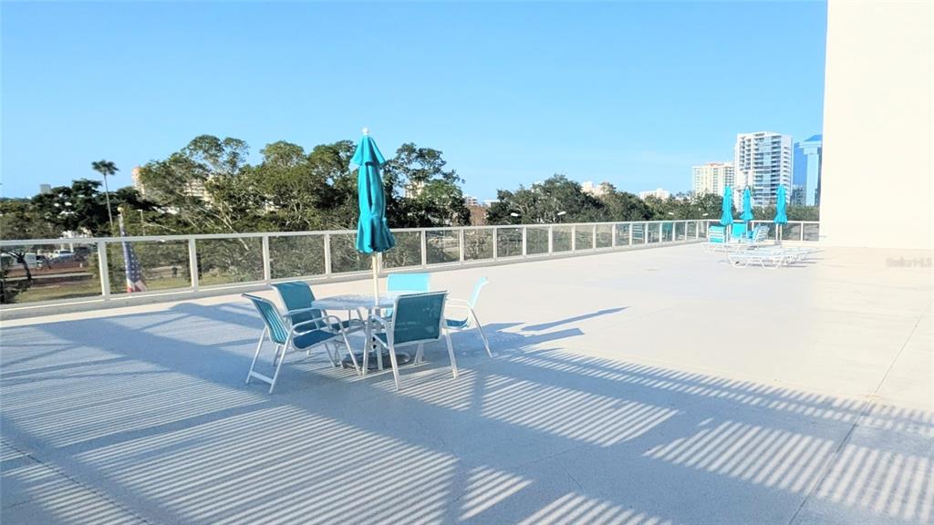 101 South Gulfstream Avenue, Unit 7E Sarasota, FL 34236 - Photo 29 of 40 a terrace with outdoor seating and city view