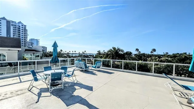 a view of dinning table and chairs on the roof deck