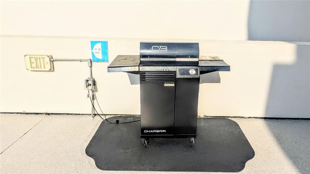 101 South Gulfstream Avenue, Unit 7E Sarasota, FL 34236 - Photo 32 of 40 a room with a table and a fireplace