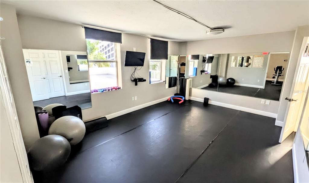 101 South Gulfstream Avenue, Unit 7E Sarasota, FL 34236 - Photo 35 of 40 a playing room with furniture and a flat screen tv